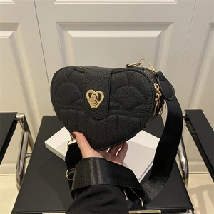 Chic black heart-shaped crossbody bag with gold lock and adjustable canvas strap