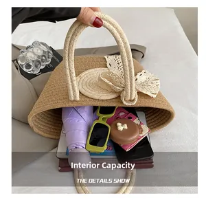 Macro shot showing large internal capacity of the straw tote bag with lace bow