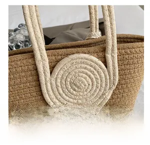 Detail of straw tote bag showing woven texture and circular straw ornament handle