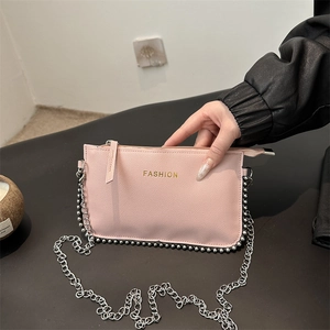 Pink minimalist crossbody bag with gold fashion lettering and silver beaded edge trim