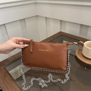 Minimalist brown pebbled leather crossbody bag with gold FASHION text and chain strap