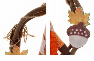 Detail of harvest gnome wreath featuring maple leaves, acorns, and rustic woven rattan