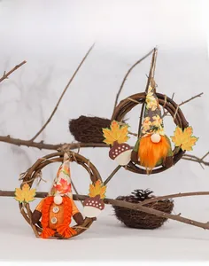 Close-up of autumn harvest gnome wreaths with maple leaves and acorns on grapevine rings
