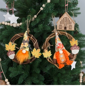 Detail of harvest gnome wreaths featuring maple leaf hats and acorns on branch rings