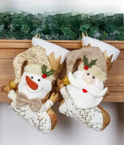 Detailed view of large gold Christmas stockings with sequins and 3D snowman hanging on mantel