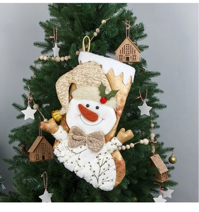 Detailed view of 3D snowman Christmas stocking with gold embroidery hanging on a tree