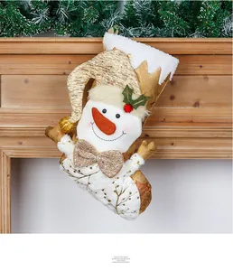 Detailed close-up of a champagne gold Christmas stocking featuring a 3D snowman figurine