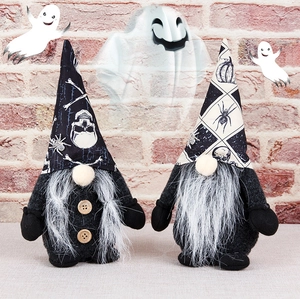 Dettagli di gnomi di peluche per Halloween con motivi a teschio su muro di mattoni