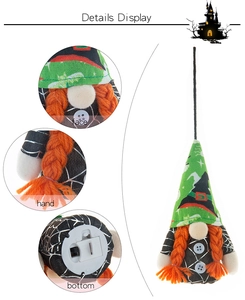 Close-up of Halloween gnome with silver spider web pattern and LED power switch