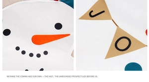 Close-up detail of honeycomb textured fabric featuring snowman and festive bunting prints