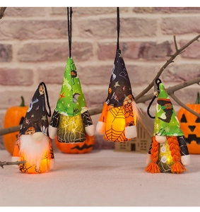Set of four lighted Halloween gnomes with warm LED glow and spooky decorative patterns