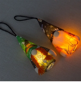 Close-up of two LED glowing Halloween gnomes with wizard hats and warm internal lights