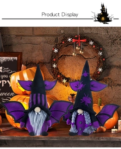 Close-up of Halloween gnomes with bat wings and spider hats in festive decor