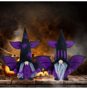 Close-up of Halloween gnome plush dolls with purple bat wings and spider wizard hats