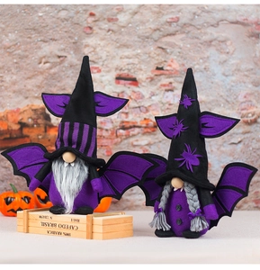 Detail of Halloween vampire gnomes with purple bat wings and fangs on brick wall