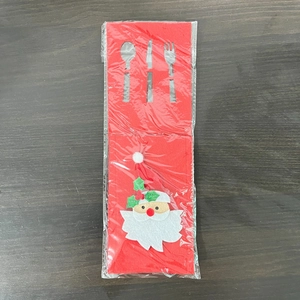 Close-up of red felt Christmas cutlery holder with Santa Claus motif in plastic bag
