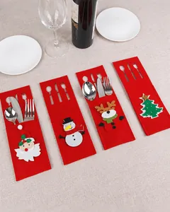 Detail of Christmas felt cutlery holders with festive Santa and snowman embroidery