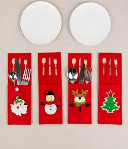 Detail view of four Christmas felt cutlery holders with Santa and Snowman designs