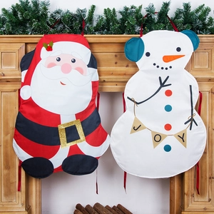 Christmas Santa and Snowman aprons hanging on a fireplace for festive decoration