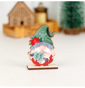 Detail of wooden Christmas gnome ornament with red coat and green snowflake hat