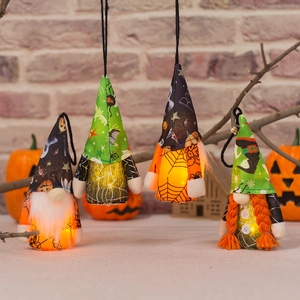 Set of 4 glowing Halloween gnome ornaments with LED lights on rustic branches