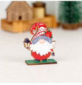 Detailed view of a festive wooden Christmas gnome gnome with red hat and a small lantern