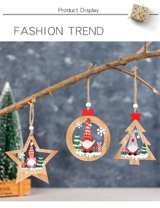 Close-up of three wooden Christmas gnome ornaments hanging on a natural branch