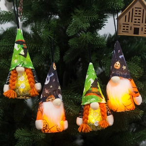 Set of four lighted Halloween gnomes with spider and pumpkin patterns on tree