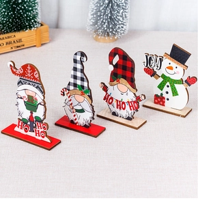 Detailed view of three festive wooden Christmas gnomes and snowman desktop ornaments