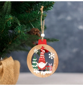 Detail of wooden gnome ornament with snowflake cutouts hanging on a Christmas tree