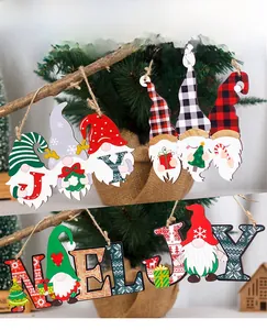 Detail of wooden Christmas gnome hanging signs with JOY and NOEL festive patterns