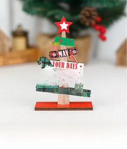Close-up of DIY wooden Christmas tree tabletop decor with festive text and red star