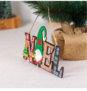Close-up of NOEL wooden gnome hanging sign with rustic twine on a Christmas tree