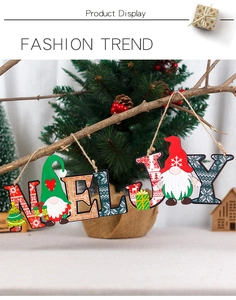 Detail of NOEL and JOY wooden Christmas gnome hanging signs with festive snowflake patterns