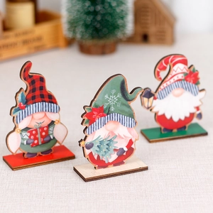 Three Nordic wooden Christmas gnomes with different hats on stands for table decoration