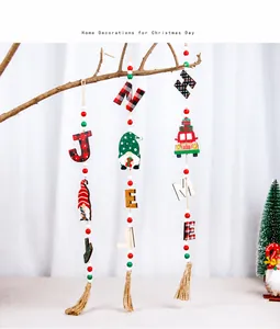 Detail of Christmas gnome wooden hanging ornaments with letter beads and jute tassels