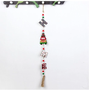 Detail of wooden HOME Christmas ornament with red truck, plaid letters and jute tassel
