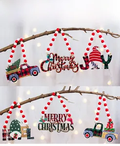 Close-up of wooden Christmas beads with Merry Christmas tags on rustic branches