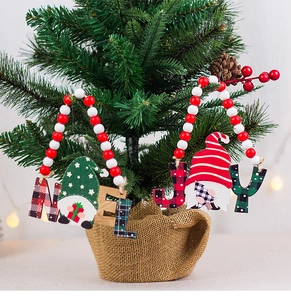 Detail of wooden NOEL and JOY Christmas ornaments with gnomes and red plaid patterns