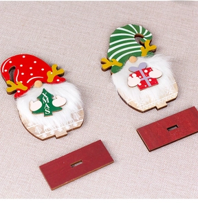 Detail of wooden Christmas gnomes with faux fur beards and decorative XMAS tree and gift box