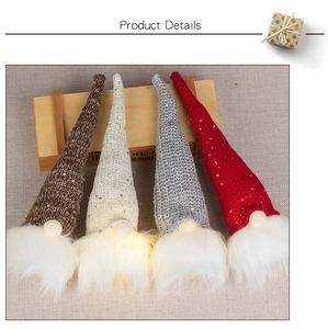 Detail showing four light-up Christmas gnomes with sequined knit hats and warm LED glow