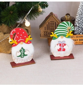 Close-up of two Christmas wooden gnomes with plush beards and reindeer antlers