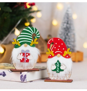 Detail of wooden Christmas gnomes with reindeer antlers and XMAS tree holding signs