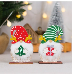 Detail of two Christmas gnomes with faux fur beards and laser-cut wooden textures