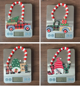 Detailed view of Christmas wooden bead ornaments being weighed for product measurements
