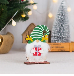 Detailed view of a wooden Christmas gnome ornament with reindeer antlers and a red gift box