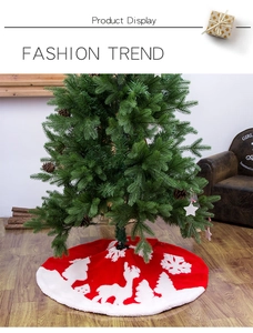 Detail of red Christmas tree skirt featuring reindeer and snowflake patterns on soft plush fabric