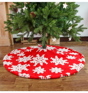 Detail of red plush Christmas tree skirt with white snowflake jacquard pattern texture