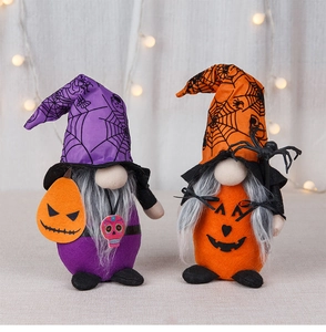 Macro shot of Halloween gnome dolls featuring spider webs and pumpkins with festive lights