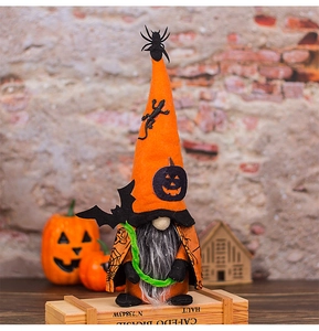 Halloween gnome plush with spider hat and bat print cloak on wooden crate
